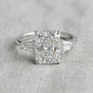 Radiant Cut Diamond Ring Rose Gold Engagement Three Stone Tapered Baguette Side Stones Luxury Bridal Jewelry Elegant Proposal Gift