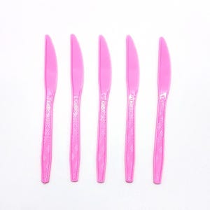 May include: A white ceramic mug with a black handle and the text "But First, Coffee" in a black, bold font. The mug is on a white surface. The mug is approximately 4 inches tall.