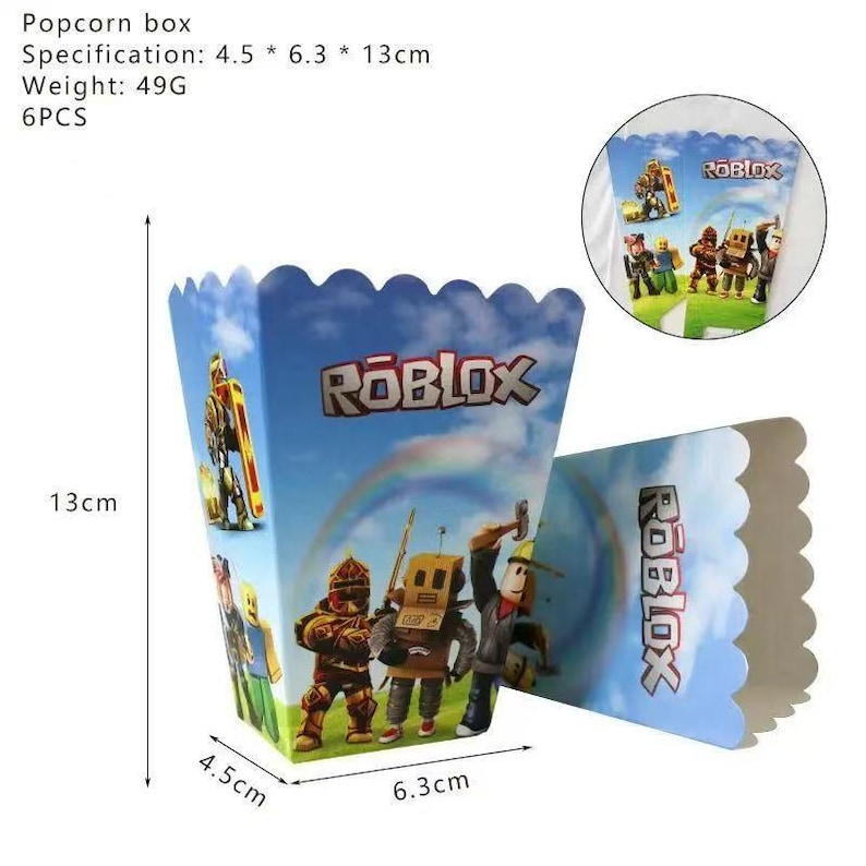 Op de afbeelding: Een blauwe popcornbox met een geschulpte rand, met het Roblox-logo en personages. De doos meet 4,5 cm x 6,3 cm x 13 cm. De doos heeft een regenboog en karakterillustraties.