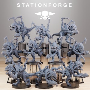 May include: A collection of gray, detailed miniature figures of alien creatures, each with multiple limbs, sharp claws, and menacing expressions. The figures are arranged on small, round platforms. The text "STATIONFORGE" and a skull logo are at the top.