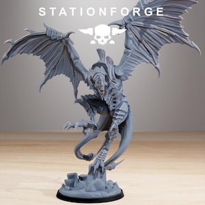 May include: A gray, detailed figurine of a winged creature with sharp claws and a menacing expression. The figure is posed dynamically, with outstretched wings and a long tail. The text "STATIONFORGE" is visible at the top.