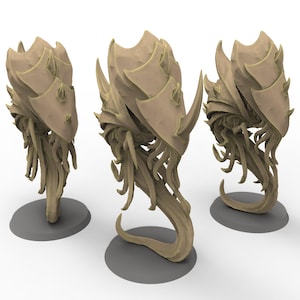 May include: Three beige, stylized, alien-like sculptures. Each sculpture has a segmented, shell-like head with horn-like protrusions and a series of tendrils. The sculptures are mounted on gray circular bases.