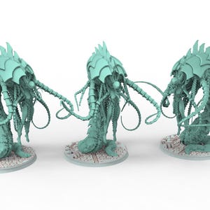 May include: Three light teal-colored, stylized creature figurines. Each figure has a segmented body, a head with a crown-like structure, and multiple tentacle-like appendages. They stand on circular, textured bases.