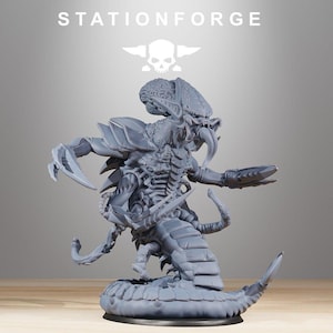 May include: A gray, detailed figurine of a creature with a segmented body, sharp claws, and a large head. The figurine has a menacing appearance, with the word "STATIONFORGE" above it.