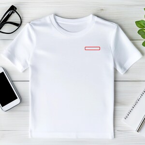 May include: A plain white short-sleeved t-shirt featuring a small, rectangular red outline graphic positioned on the upper left chest area. The garment has a classic crew neckline and a simple, clean design suitable for casual wear.
