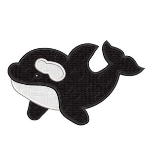 May include: A black and white orca whale applique with a textured appearance. The orca features a white belly, eye patch, and accents, with a black outline. The design is suitable for various craft projects.