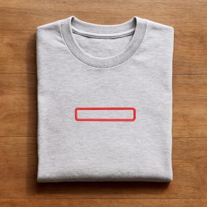 May include: A light gray crew neck t-shirt featuring a simple, embroidered red rectangular outline centered on the chest. The garment is made of a soft, heathered fabric with a ribbed collar and short sleeves, presented in a clean, folded layout.