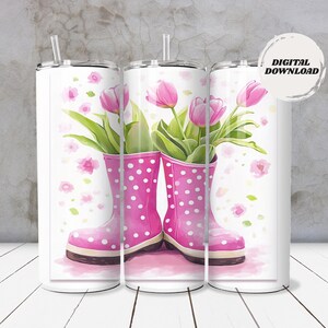 May include: A white tumbler with a watercolor design featuring pink rain boots with white polka dots, filled with pink tulips and green leaves. The tumbler has a silver straw and the words "DIGITAL DOWNLOAD".