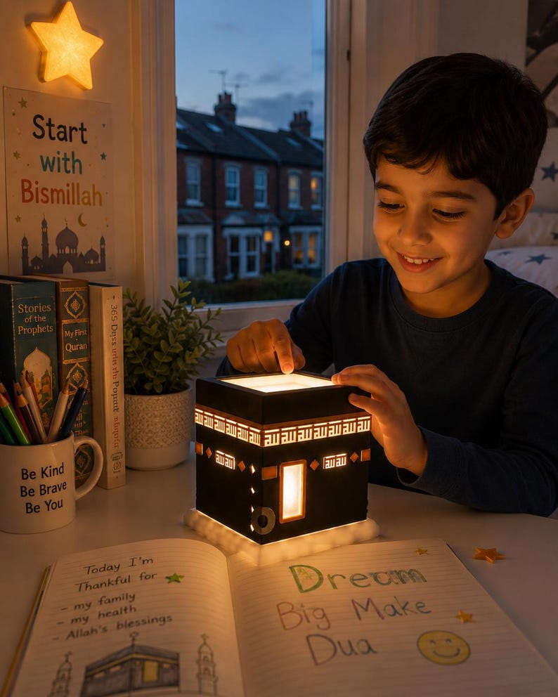 Young child enjoying a warm illuminated Kaaba night light during quiet evening reading time.