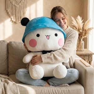 May include: A white ceramic mug with a black handle and the text "But First, Coffee" in a black, bold font. The mug is on a white surface.