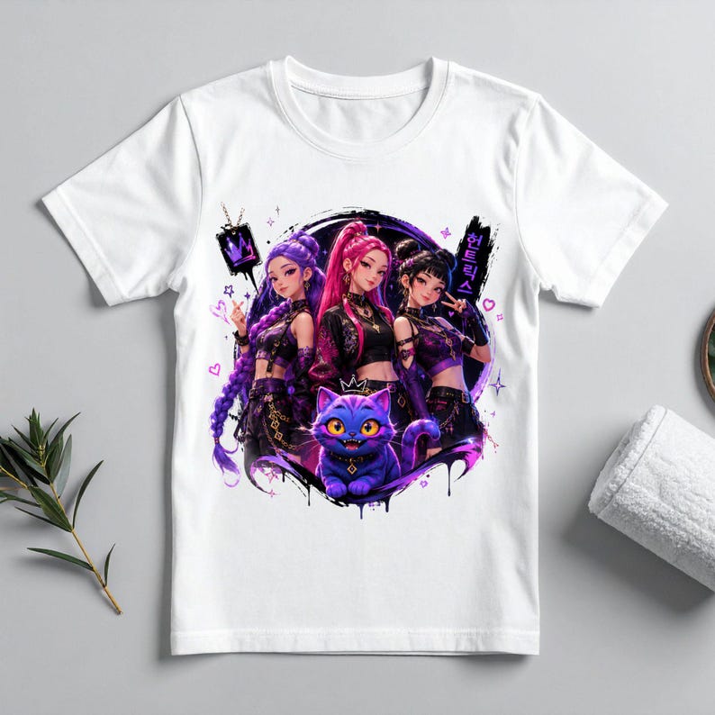 Pode incluir: Uma t-shirt branca de manga curta com uma impress&atilde;o gr&aacute;fica de tr&ecirc;s personagens estilo anime com cabelo roxo e rosa, vestidos com roupas escuras, posicionados acima de um gato roxo estilizado com grandes olhos amarelos e uma coroa.