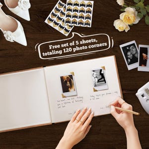 以下が含まれることがあります： 結婚をテーマにしたフラットレイ。フォトアルバム、2枚の写真、フォトコーナー、ペンが写っています。「Free set of 5 sheets, totaling 120 photo corners」と書かれたテキスト。白いブライダルシューズと花も写っています。