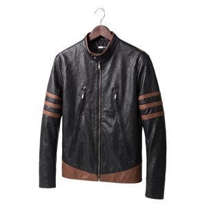 May include: A black jacket with a stand-up collar, a full-length front zipper, and two diagonal zippered chest pockets. The sleeves feature three horizontal brown stripes, and the bottom hem is accented with a brown panel.