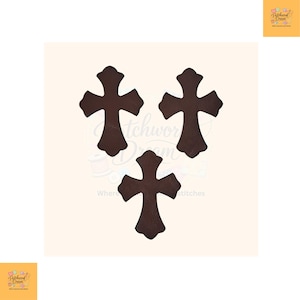 May include: Three dark brown cross-shaped appliqués with a smooth, solid finish. Each cross features a distinct flared design at the ends of the arms and the base, arranged in a triangular formation against a light-coloured background.