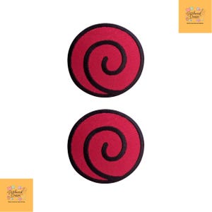 May include: Two circular embroidered patches featuring a vibrant red background with a bold black spiral design centered on each. The patches have a solid black stitched border around the circumference, creating a clean and defined edge for application.