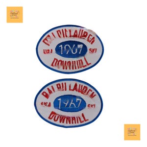 May include: Two oval-shaped patches with a white background and a blue and red design. The patches have the text "PAI DILLAUDER 1967 DOWNHILL" and "PAI DILLAUDER 1967 DOWNHILL" in red and blue. The patches are likely vintage ski patches.