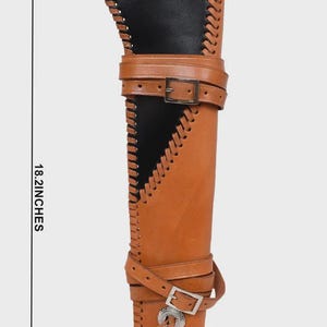 May include: A brown leather quiver with a black interior, measuring 18.2 inches in height, 5.9 inches wide, and 4 inches deep. It features stitched edges, adjustable straps with buckles, and a decorative silver-colored concho.