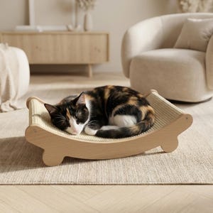 May include: A calico cat rests peacefully on a wooden cat bed. The bed has a curved, light-colored wooden frame with a woven beige surface. The cat's fur is a mix of black, brown, and white.