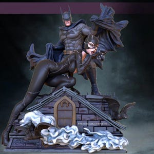 May include: A detailed statue featuring Batman and Catwoman on a rooftop. Batman stands tall in a gray suit and cape, while Catwoman crouches in a black catsuit. The base includes a bat and the text "www.patreon.com/DX03Dprinting".