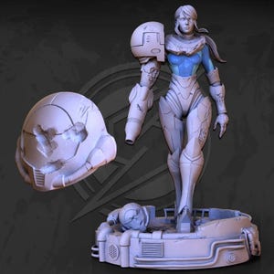 May include: A detailed, light-colored figurine of a female character in futuristic armor, with a detached helmet and a base. The armor has intricate details and a blue underlayer is visible. The figure is posed in a standing position.