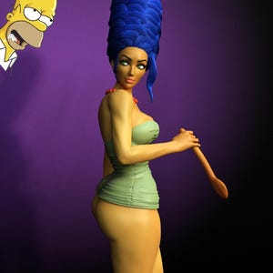May include: A figurine of a character with tall blue hair, green eyes, and a red necklace, wearing a strapless light green dress and holding a wooden spoon. A small illustration of a yellow cartoon character with a white shirt is in the corner.