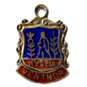 May include: Silver charm with a blue and white enamel design. The charm features a walking figure with plants on either side. The charm is inscribed with the words "NYCEIA VENTNOR".
