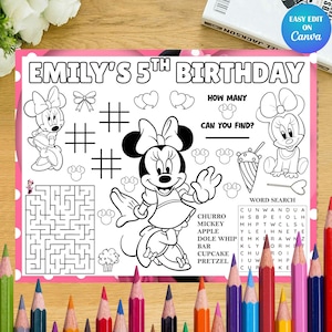 May include: A white ceramic mug with a black handle and the text "But First, Coffee" in a bold, black font. The mug is set against a blurred background, suggesting a cozy setting.