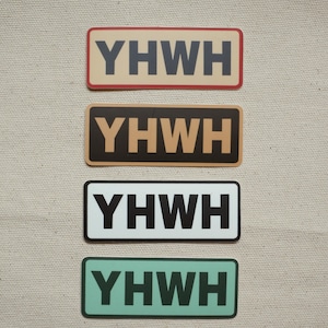 Puede incluir: Cuatro pegatinas rectangulares con las letras "Y H W H" en negrita. Las pegatinas tienen diferentes combinaciones de colores: beige con borde rojo, marrón, blanco con borde negro y verde azulado.