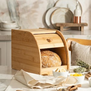 May include: A rustic wooden sign with the text "Welcome to our home" in white lettering. The sign features a distressed finish and a simple, inviting design, perfect for entryway decor.