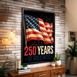 May include: A framed print featuring the American flag waving against a black background. The text "250 YEARS OF GREATNESS" is displayed in red and white, with blue stars. The print is displayed on a brick wall.