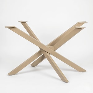 May include: A beige metal table base featuring an X-shaped design with four angled legs. The structure includes flat rectangular mounting plates at the top of each leg for attachment to a tabletop, providing a stable support frame for furniture.
