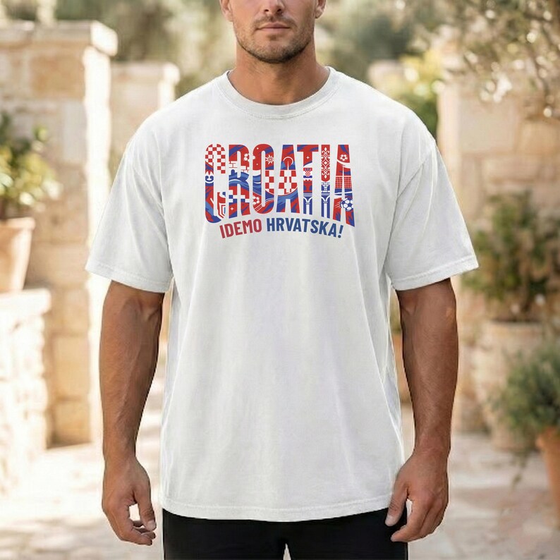 May include: White t-shirt with the word "CROATIA" in red, white, and blue, with various Croatian-themed graphics. Below the word is the phrase "IDEMO HRVATSKA!"
