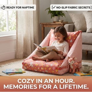 May include: A pink floor chair with a floral and deer pattern, featuring side straps and a backrest. The text READY FOR NAPTIME and NO-SLIP FABRIC SECRETS appear at the top, with COZY IN AN HOUR. MEMORIES FOR A LIFETIME. at the bottom.