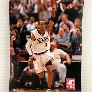 May include: A stack of Philadelphia 76ers basketball cards featuring Allen Iverson in a white jersey with the number 3. The image includes the team logo and text from the Daily News and The Inquirer.