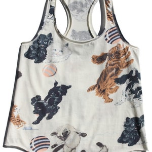 May include: A white tank top with a playful print of cats and dogs playing with balls. The print is in shades of black, brown, white, and gray.