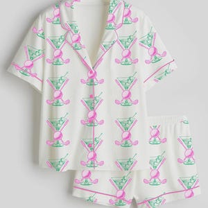 May include: A white ceramic mug with a black handle and the text "But First, Coffee" in a black, handwritten-style font. The mug is likely 11-15 ounces in size, perfect for a morning beverage.