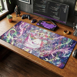 May include: A large rectangular desk mat featuring a colorful anime-style illustration. The design includes a figure in a flowing white dress, surrounded by swirling purple, pink, and green elements. The mat is on a wooden desk with a keyboard and mouse.