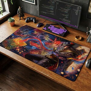 May include: A rectangular gaming mousepad featuring a colorful illustration of a character in a hat, holding playing cards. The design incorporates red, blue, and gold hues, with a dark background. A purple keyboard and computer monitor are visible.