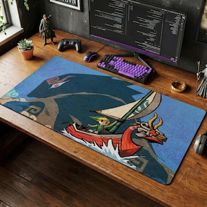 May include: A rectangular desk mat featuring a printed illustration of a character with blonde hair in a red boat with a white sail, navigating blue water. A large, dark blue, stylized creature silhouette is visible in the background of the design.