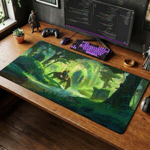 May include: A rectangular desk mat featuring a vibrant, detailed illustration of a forest landscape with a rider on horseback approaching a stone archway. The artwork uses shades of green, yellow, and brown to depict trees, ruins, and foliage.