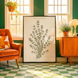 May include: A large rectangular framed wall art print featuring a botanical illustration of a thyme plant with small leaves and flowers. The text NEW LEAF BOTANICAL is printed in black at the top center of the off-white paper within a black frame.
