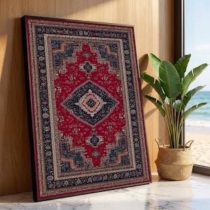 May include: Framed Persian-style rug print. The rug features a central red field with a navy blue diamond-shaped medallion and intricate border designs in navy, red, and cream. The framed print is leaning against a wooden wall, with a plant in a woven basket nearby.