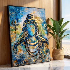 May include: A framed painting of a blue-faced deity with long hair and a calm expression. The artwork features gold accents and a trident, set against a backdrop of blue and gold hues. The painting is displayed near a potted plant.