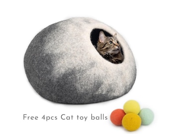 May include: A gray and white felt cat bed shaped like a rounded dome with a cat inside. The bed has a hole for the cat to enter. Four colorful felt cat toy balls are included.