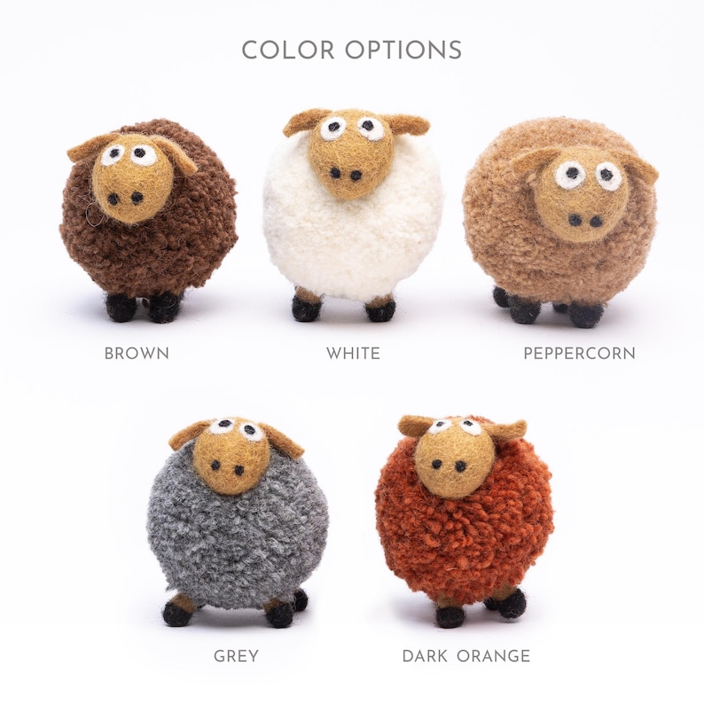 May include: Five felt sheep toys in different colors: brown, white, peppercorn, grey, and dark orange. The sheep are all the same size and have black eyes and noses.