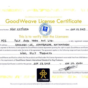 May include: A GoodWeave License Certificate, featuring a gold and white design with text. The certificate verifies Felt and Yarn Pvt. Ltd. as a licensee for wool felt products. The certificate is valid from September 13, 2019, to September 12, 2020.