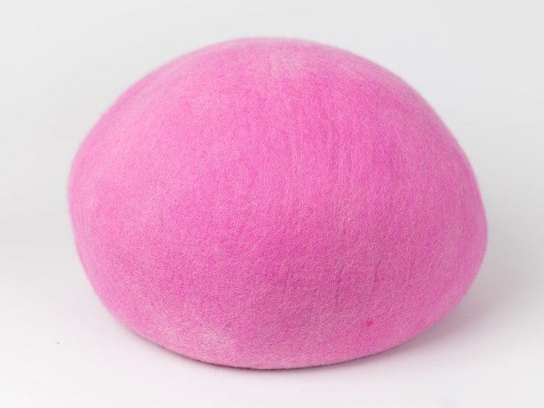 May include: A bright pink felt ball. The ball is soft and fuzzy.