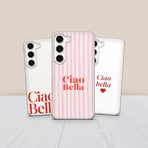 May include: Three white phone cases with the text "Ciao Bella" in red. One case has pink vertical stripes. The other two cases have the text "Ciao Bella" in red. One case has a red heart.