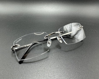 Gafas Cartier Lanark vintage sin montura, con acabado platino y detalles en ónix, auténticas de Francia.