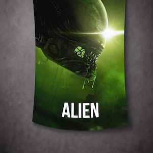 May include: A green and black tapestry featuring a close-up of an alien creature's head with sharp teeth and glowing eyes. The word "ALIEN" is printed in white at the bottom. The background is a dark green.